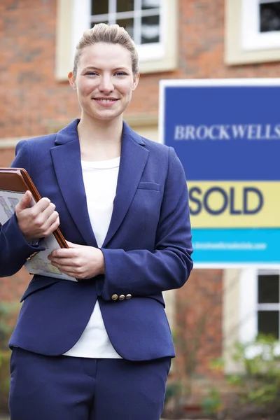 Porträt einer Immobilienmaklerin, die vor einem Wohnhaus steht — Stockfoto