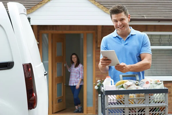 Portrait Of Driver Delivering Online grocery Order To House Usin — стоковое фото