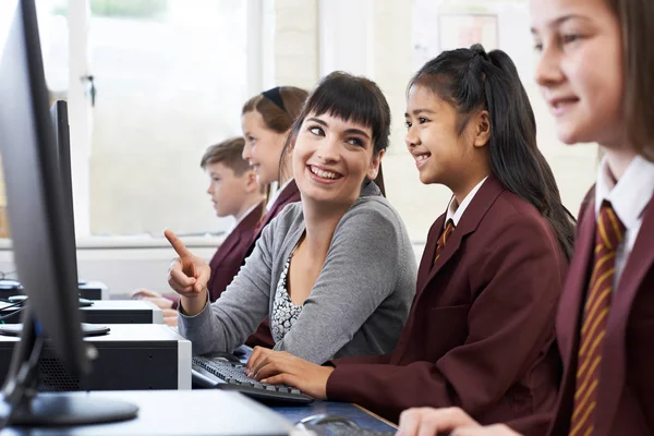 Alumnos con uniforme en clase de informática con profesora —  Fotos de Stock