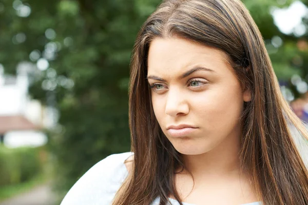 Outdoor Head And Shoulders Shot Of Serious Teenage Girl — Stock Photo, Image