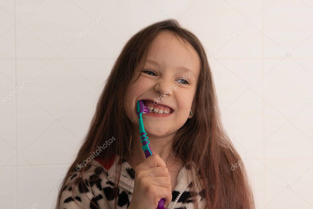 Little girl brushing her teeth. Girl with a toothbrush. Oral hygiene.