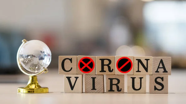 Concept Coronavirus. Prevent or stop the spread of the corona virus worldwide. Letters on the wooden floor resting on a wooden table. Tourists stop travel to travel from China. And related country