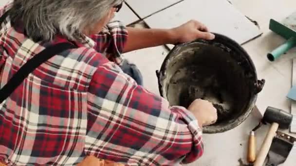 Construction Workers Technicians Mixing Cement Bucket Using Trowel Sit Construction — Stock Video