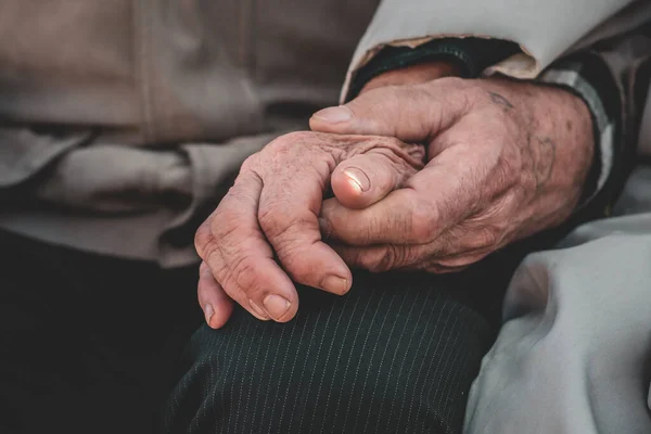 Old people holding hands. Close up.