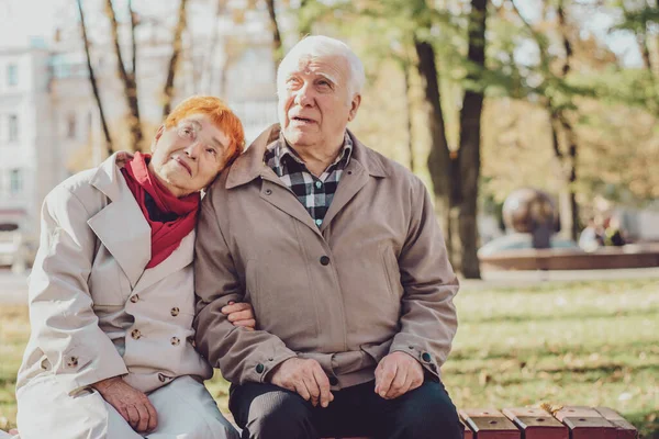 Happy seniors taking a walk in the park on sunny day. Old senior family concept.