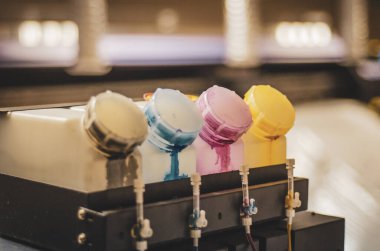 Renkli mürekkep tankı ya da basım işi için fabrikada büyük bir yazıcı makinesi. Boşluğu kopyala