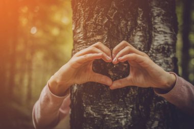 Kalbini ağaçla paylaşan bir kız.