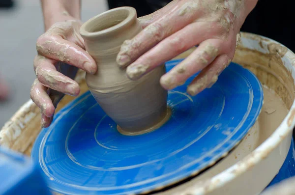 Street master class on modeling of clay on a potter\'s wheel In the pottery workshop