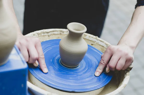 Street master class on modeling of clay on a potter\'s wheel In the pottery workshop