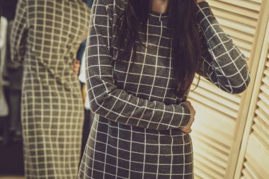 Şık kıyafetler içinde şık, güzel model esmer kız, giyim mağazasında poz veriyor, yeni bir moda. Bir giyim mağazasının afişi. Galeriler, moda mağazaları, kapak hikayeleri, dahili stüdyolar için.