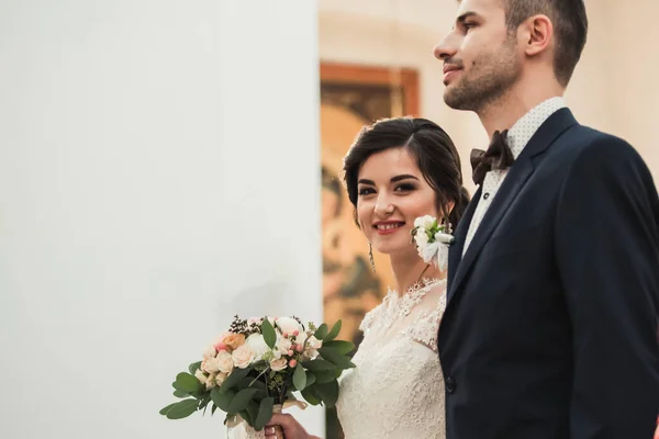 Loving Bride and groom in the church before the wedding when they become husband and wife in anticipation of the ceremony, copy space