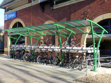 Two-tier cycle parking at Rickmansworth Station. A fifty space cycle rack with canopy at railway transport hub. clipart