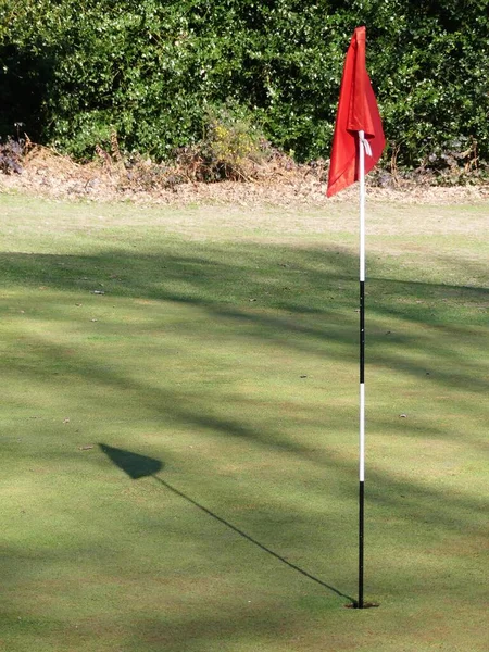 Golf Green Red Flag Casting Shadow — Stock Photo, Image