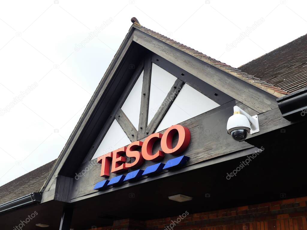 Tesco supermarket sign atop a store exterior, Amersham, Buckinghamshire, England, UK