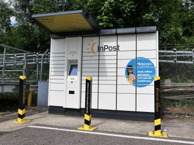 InPost online shopping pickup point with parcel lockers at London Underground Station clipart