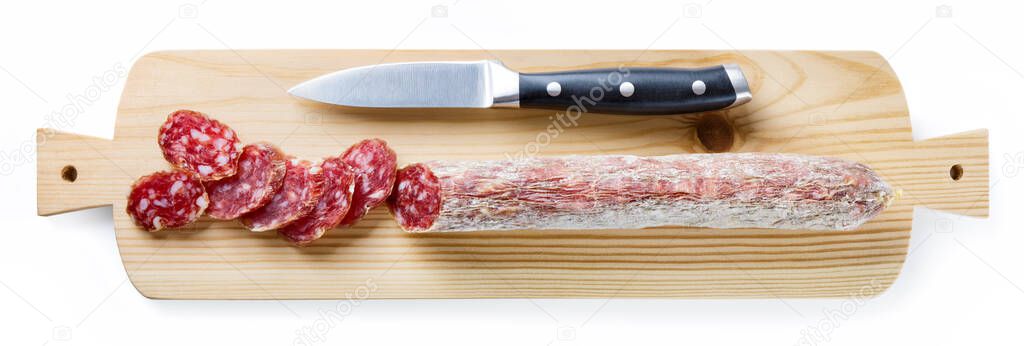 Sliced salami, knife and chopping board isolated on white background, top view.