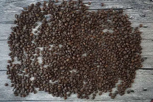 lots of coffee beans on a wooden table