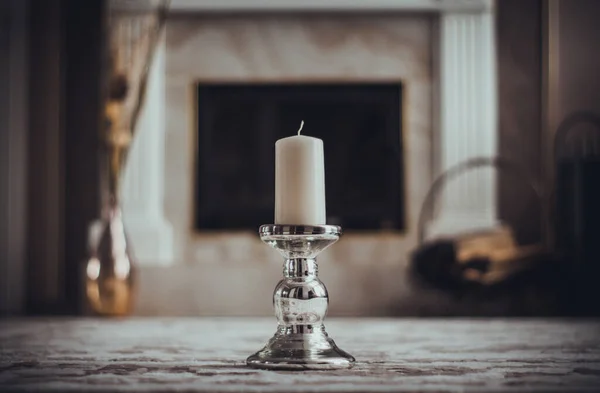 Candle Silver Candlestick Blurry Fireplace Background — Stock Photo, Image