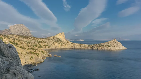 Panorama of the Tsar's blue bay on the background of the Crimean mountains of Kapchik Cape, Sokol mountain, Oryol mountain Crimean Meganon mount coast of Sudak nature reserve Novy Svet