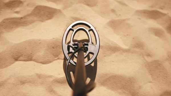Поисковая катушка металлодетектора сканирует песок на пляже. Снимок точки зрения — стоковое фото