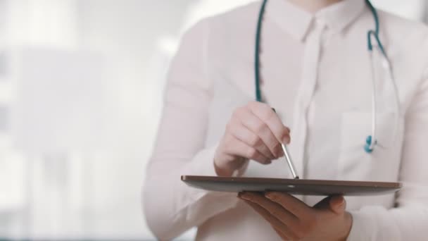 Healthcare and technology. Doctor working on digital tablet in hospital — Stock Video