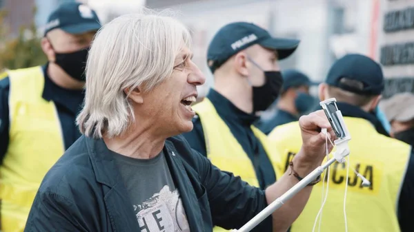 Warszawa, Polen, 05.07.2020. - Protestera mot företagarna. Man går live med smartphone talar på hörlurar mikrofon — Stockfoto