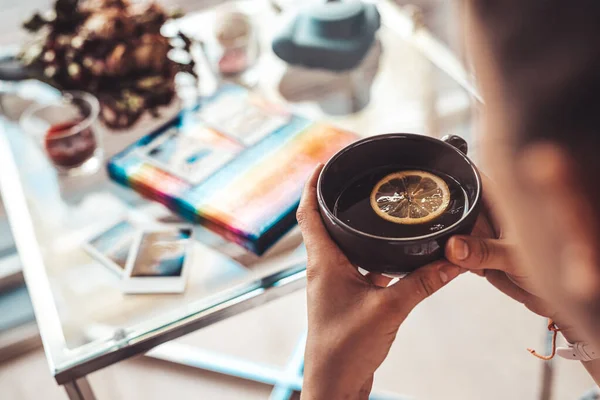 Woman relaxes at work with a cup of tea