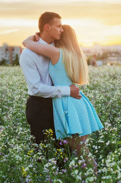 Romantic couple running in field holding hands. Couple enjoying