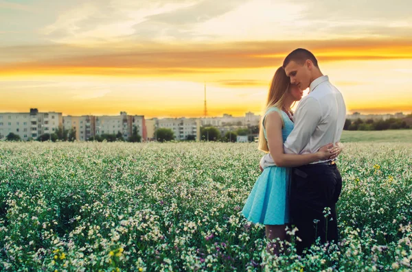 Romantic couple running in field holding hands. Couple enjoying