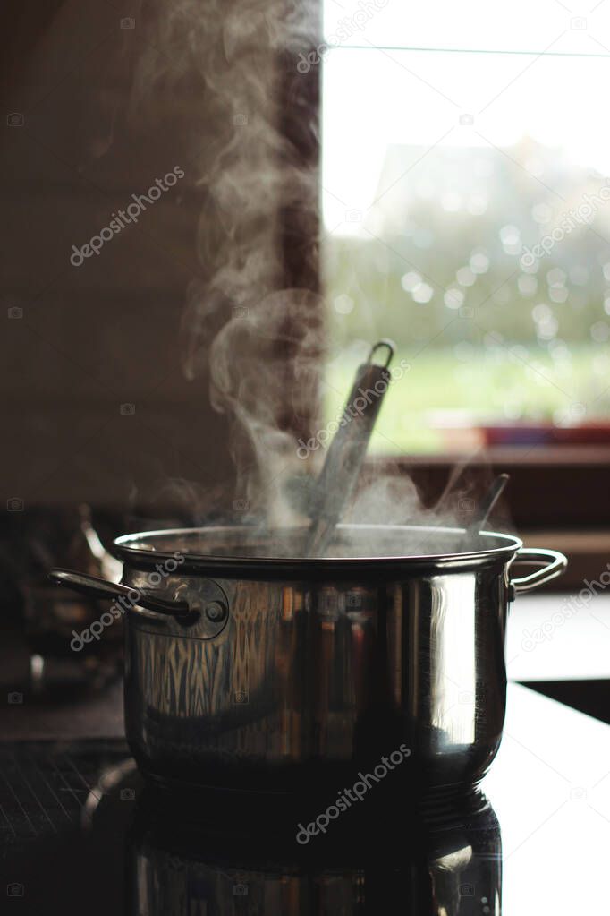 Pot and steam in the kitchen, aroma.