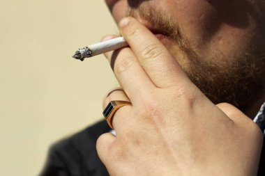 Sigara içen bir adam. El..