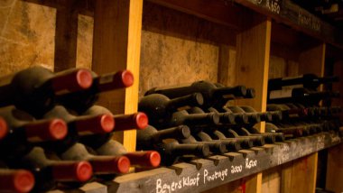 stored vintage bottles in winery cellar, stellenbosch, south africa clipart