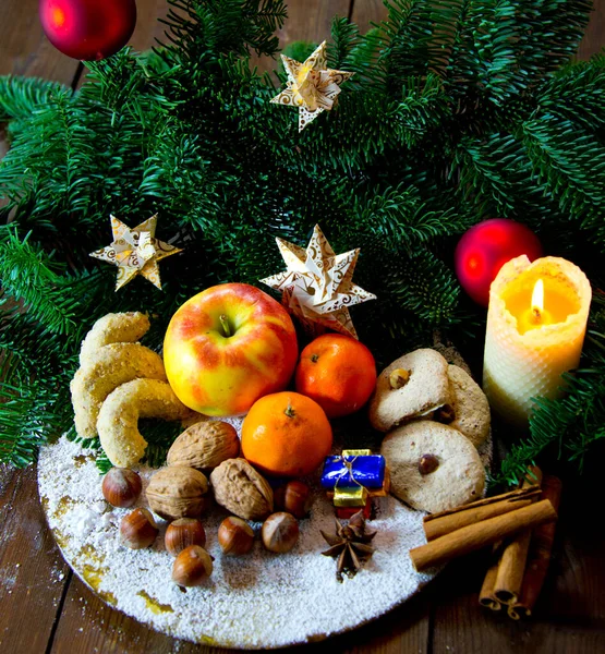 ナッツと伝統的なドイツのクリスマスのお菓子プレートQndクッキースパイス モミの枝や紙の星で飾られた — ストック写真