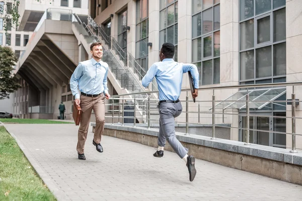 Two businessmen running to meet each other — Stock Photo, Image