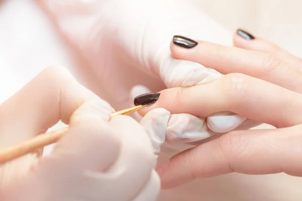 Schoonheidsspecialiste Poolse nagels op vrouwen toe te passen — Stockfoto