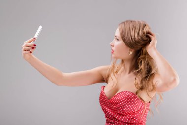 sarışın bir kadın selfie telefona yapar.