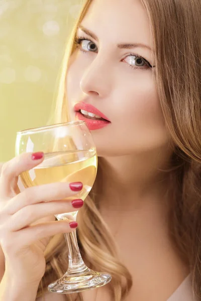 Sexy blond woman with a glass of champagne at party — Stock Photo, Image