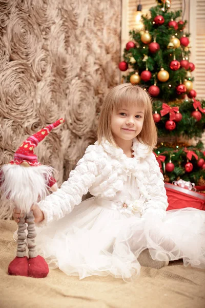 Улыбающаяся девушка с рождественской игрушкой — стоковое фото