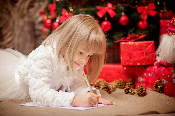 Little girl writes a letter to Santa Claus — Stock Photo, Image