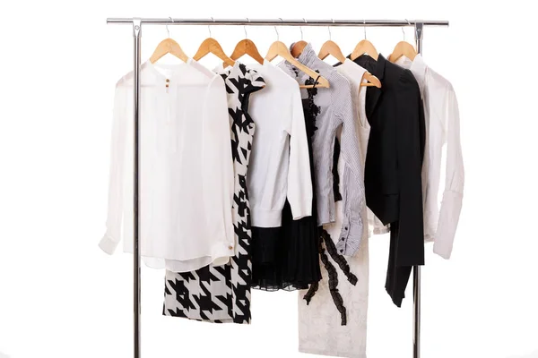 Black and white womens clothes on hangers on rack on white backg — Stock Photo, Image