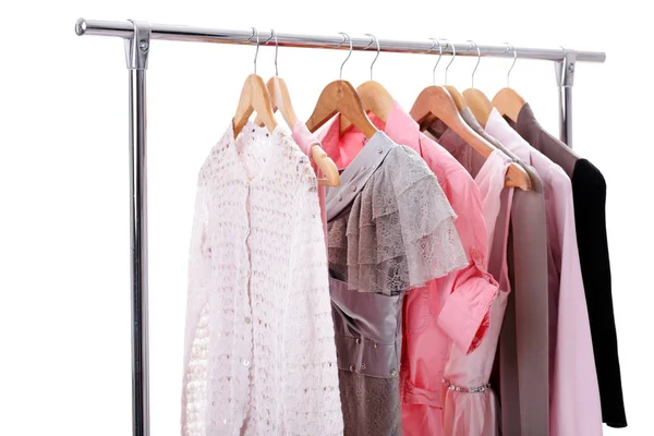 Gray, pink womens clothes on hangers on rack on white background — Stock Photo, Image