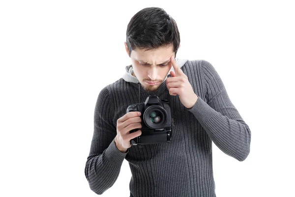 Young photographer sets up the camera isolated on white backgrou Stock Image