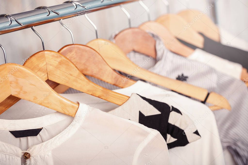 black and white womens clothes on hangers on rack in fashion sto