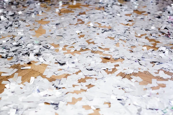 silver confetti on the floor.