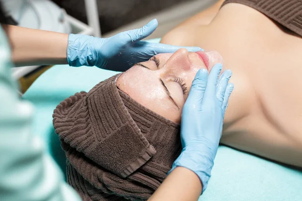 Антивозрастной массаж лица. косметолог делает массаж молодой женщине в Спа салоне . — стоковое фото