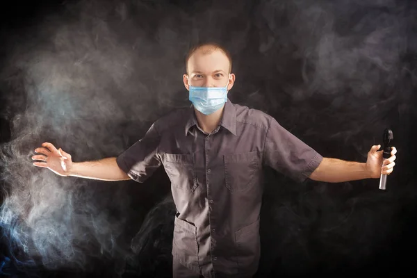 Young doctor in a mask in smoke — Stock Photo, Image