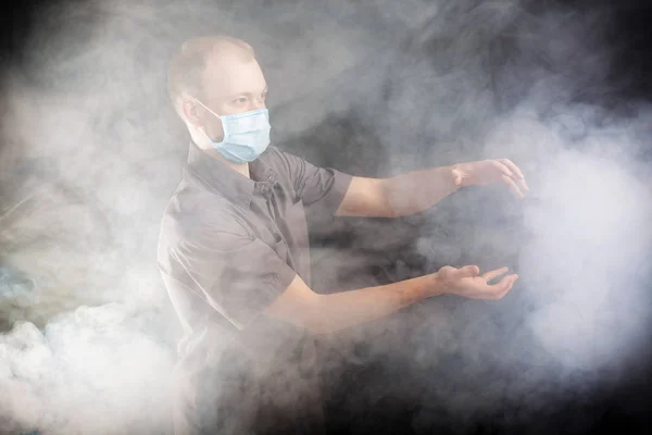 Jonge dokter in een masker in rook — Stockfoto