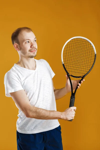 黄色の背景にテニスをする若いテニス選手 — ストック写真