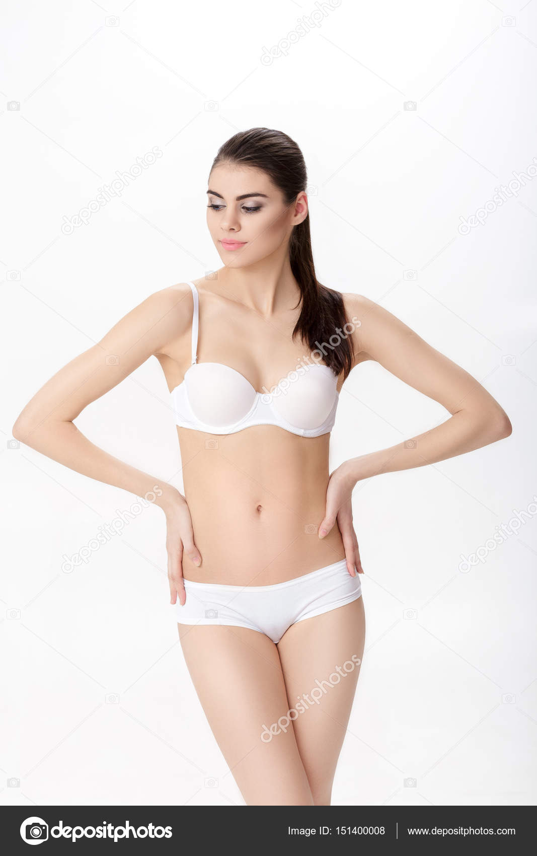 Premium Photo  Pretty petite brunette woman in a small black sports bra on  a white background