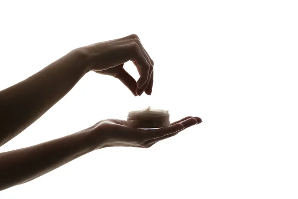 Silhouette of female hands holding face powder isolated on white background — Stock Photo, Image